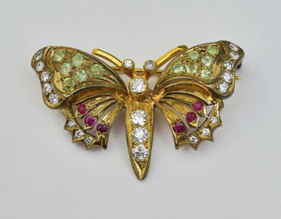 14k Gold Butterfly Brooch: set with diamonds, rubies and yellow colored stones, 1 1/2" wide, 1" high, weight is 4.3 dwt gross