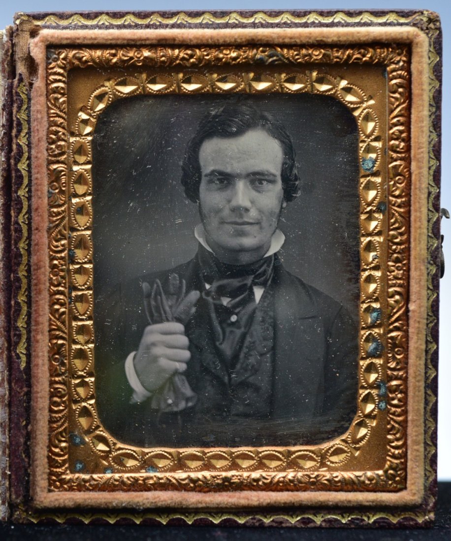 Ninth Plate Daguerreotype of an Ernest Gentleman clenching Gloves: Ninth Plate Daguerreotype of an Earnest Gentleman clenching Gloves, 2 3/8"x2", with embossed leather case, mid-19th century
