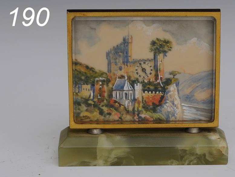 SWISS BRONZE AND ONYX TABLE CLOCK with painted cas: SWISS BRONZE AND ONYX TABLE CLOCK with painted castle scene 3 3/4" x 3 1/2" overall circa 1920 Shipping Information: Shipping available within the Continenal USA (excludes insurance)$25