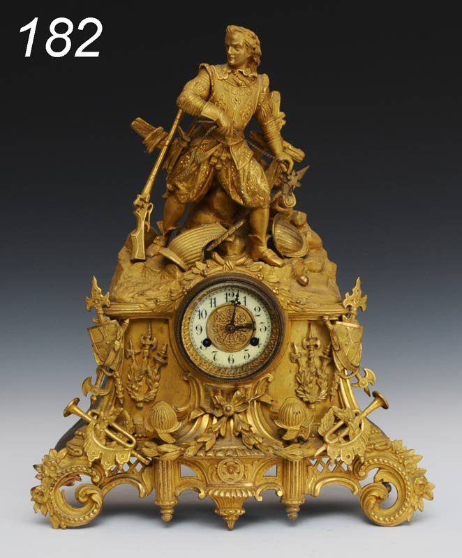 GILT BRONZE FIGURAL MANTLE CLOCK with movement sig: GILT BRONZE FIGURAL MANTLE CLOCK with movement signed "Waterbury Clock Co." 18" high, circa 1875 Shipping Information: Shipping available within the Continenal USA (excludes insurance)$60