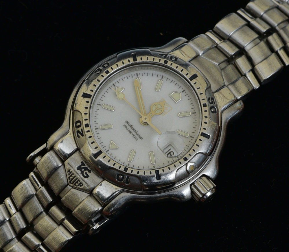 Tag-Heuer Professional 200 Meters Ladies Wrist Watch: Stainless Steel with white dial and date window,28mm diameter case, quartz movement case stamped "Wh1311-k1" SHIPPING AVAILABLE IN-HOUSE WITHIN THE CONTINENTAL U.S. FOR $25