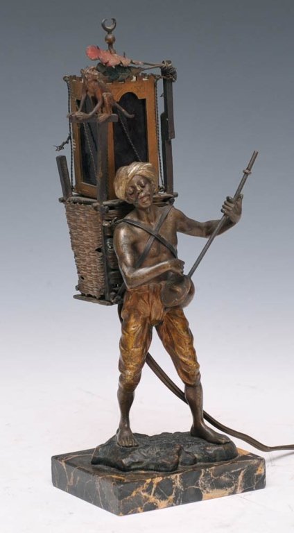 Austrian Cold Painted Bronze Lamp: in the form of an Arab musician carrying a lantern attributed to Franz Bergman 12" high overall circa early 20th century estimate 1000/1500 $35 Shipping available within the Continental USA . This amo