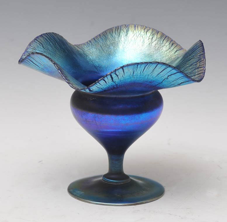 Tiffany Favrile Compote: blue with ruffled rim signed 4 3/8" high estimate 400/600 $30 Shipping available within the Continental USA . This amount excludes insurance which will be calculated based upon the selling price. All