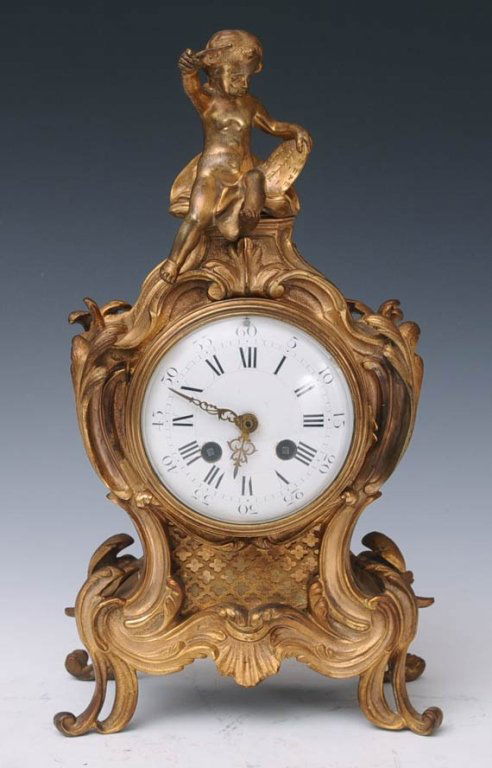 French Bronze Mantle Clock: Rococo Revival style 14" high late 19th century estimate 300/500 $60 Shipping available within the Continental USA . This amount excludes insurance which will be calculated based upon the selling pric