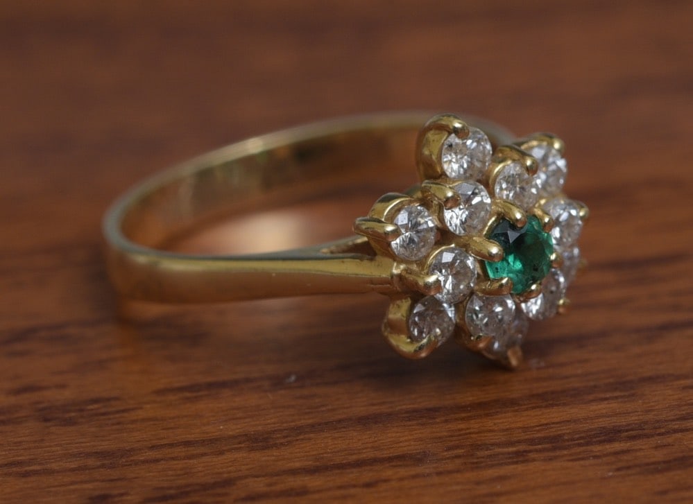 14k Gold Emerald and Diamond Ring: 14k Gold Emerald and Diamond Ring in the form of a flower with center emerald surrounded by 12 diamonds approximately .45 ct tw diamonds ring size 5, weight is 2.4 grams gross IN HOUSE SHIPPING