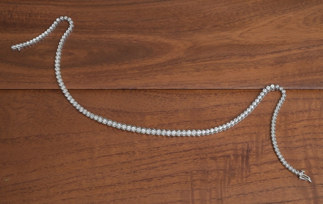 14k White Gold Diamond Necklace: 14k White Gold Diamond Necklace set with 121 graduated diamonds, measuring approximately .13 ct to .03 ct each approximately 7 ct tw 16" long weight is 27.6 grams gross IN HOUSE SHIPPING Within