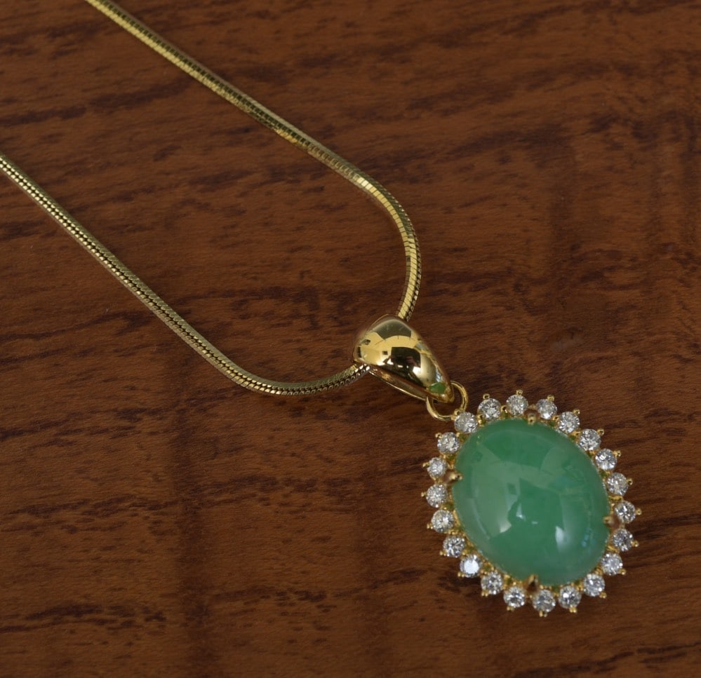 18k Gold Jade and Diamond Pendant Necklace: 18k Gold Jade and Diamond Pendant Necklace jade cabochon 13 mm x 11 mm surrounded by 22 round diamonds on a 15 1/2" long 18k gold chain weight is 9.8 grams gross IN HOUSE SHIPPING Within Continental U