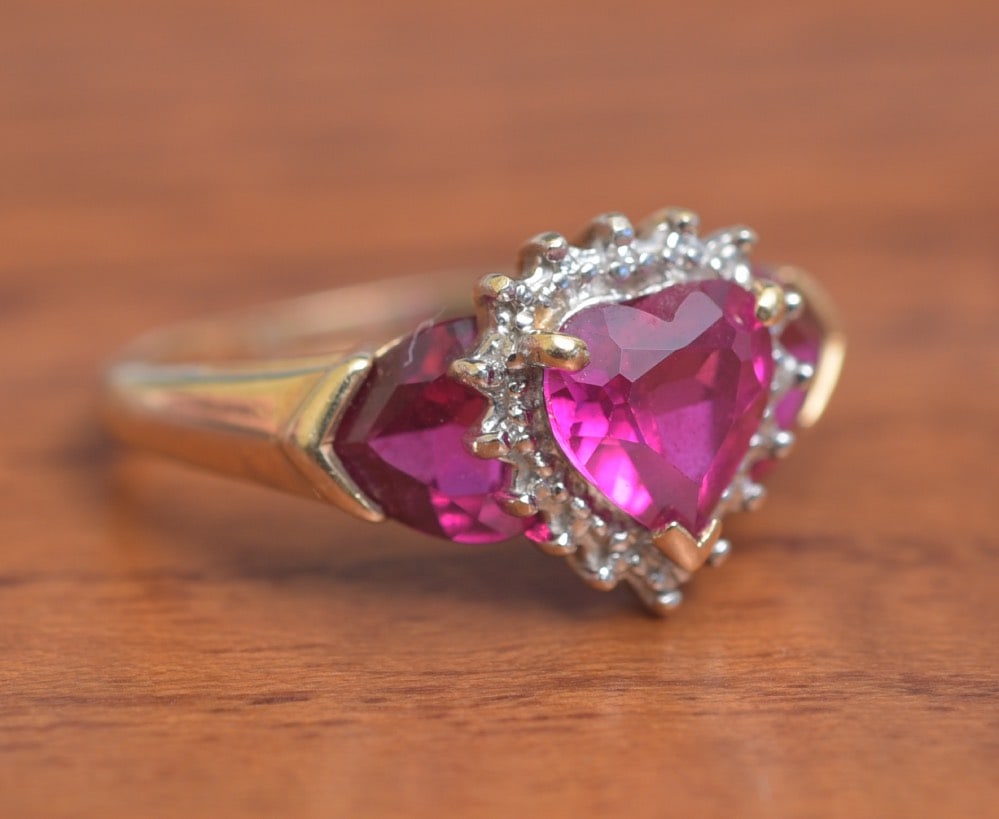 10K Gold Synthetic Ruby "Heart" Ring: 10K Gold Synthetic Ruby "Heart" Ring three stones in the form of hearts ring size 5, weight is 2.9 grams gross IN HOUSE SHIPPING Within Continental USA $25 DURING CHECKOUT CHOOSE "ARRANGE MY OWN