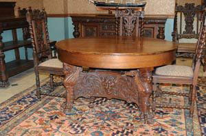 Victorian Carved Oak Dining Room Set: with winged maidens and northwind faces associated pieces including: china cabinet 50" wide, 68" high, dining table 53 1/2" diameter sideboard 72" wide, server 46" wide set of 8 chairs estimate 4000/6