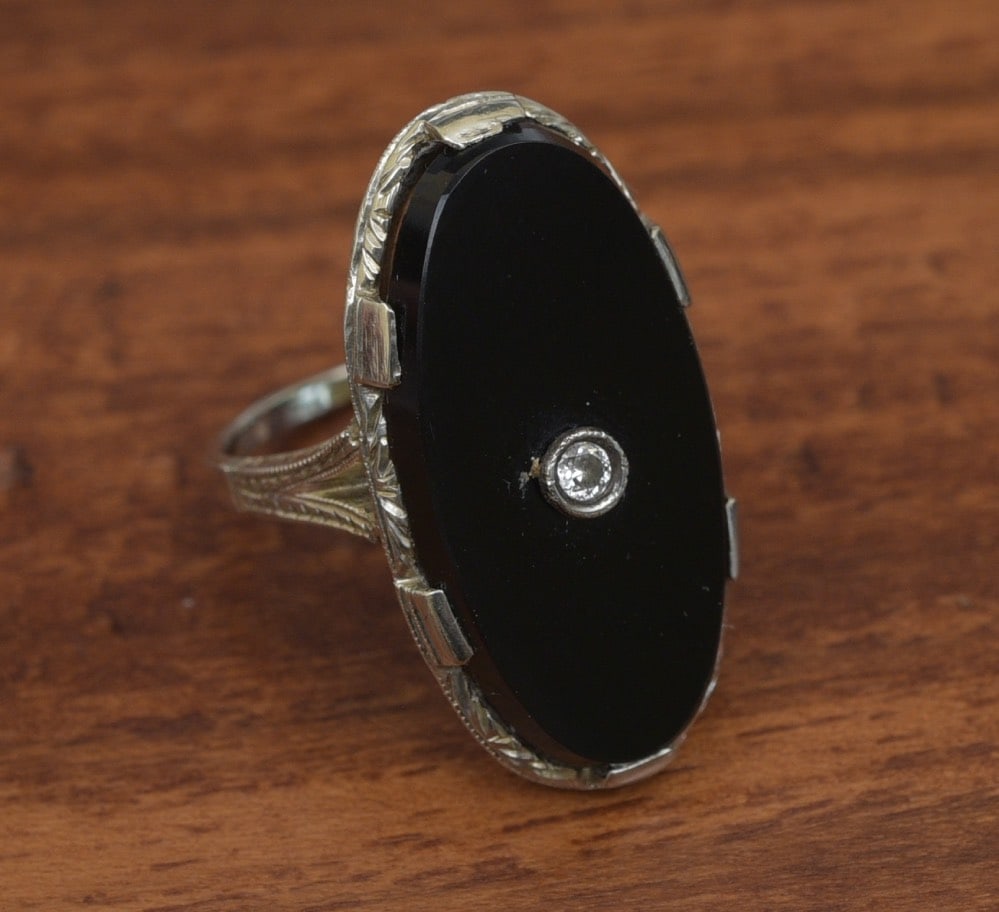 18k Gold Onyx and Diamond Ring: 18k Gold Onyx and Diamond Ring approximately 23 mm x 11 1/2 mm onyx set with a diamond ring size 5 1/2, weight is 5.3 grams gross IN HOUSE SHIPPING Within Continental USA $25 DURING CHECKOUT CHOOSE