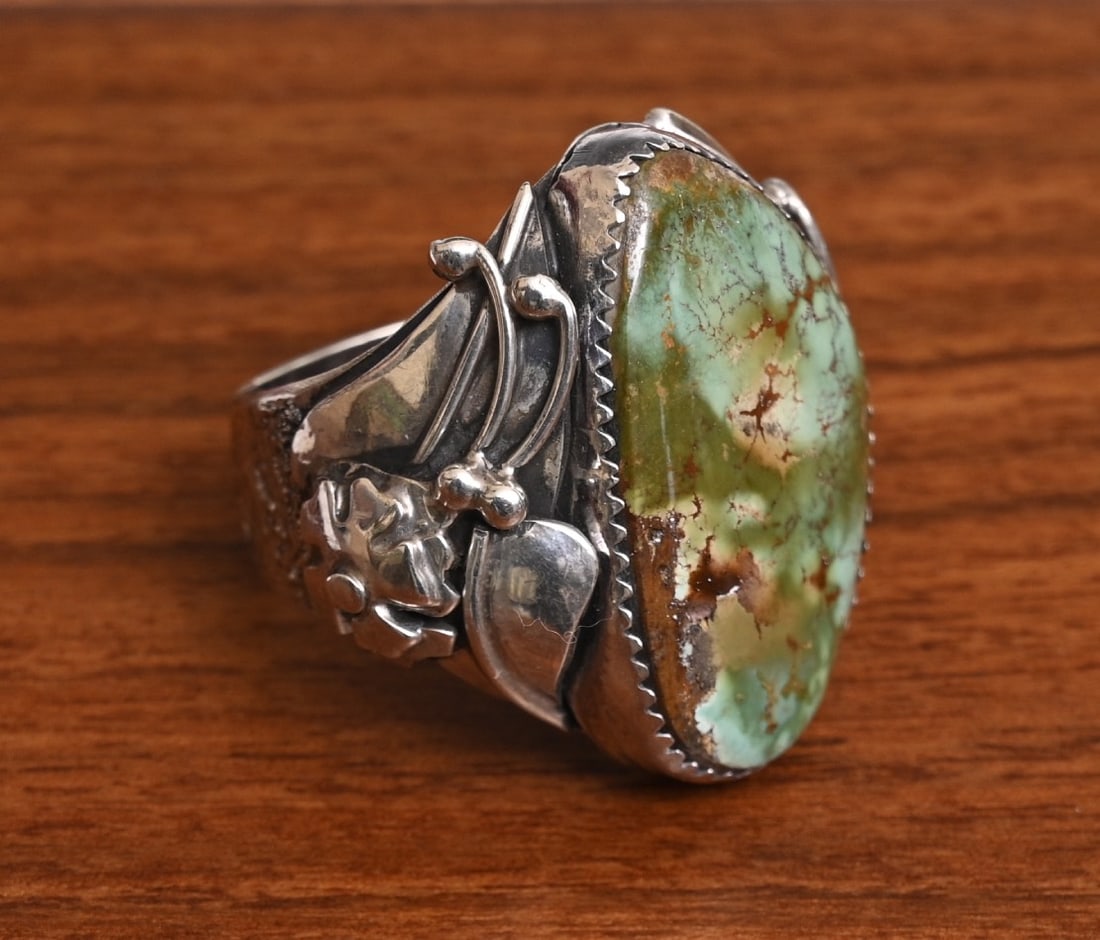 Dan Nieto Turquoise and Sterling Silver Ring, Zuni artist: Dan Nieto Turquoise and Sterling Silver Ring, Zuni artist floral motif, with turquoise 17 mm x 28 mm ring size 10, weight is 21.3 grams gross stamped "Dan Nieto" "Sterling" IN HOUSE SHIPPING within th
