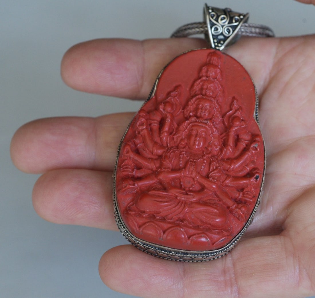 Sterling Silver Carved Cinnabar Asian Pendant Necklace: Sterling Silver Carved Cinnabar Pendant Necklace depicting a seated Hindu Goddess Durga carving 2 1/2" x 1 5/8", pendant 3" long overall, chain 17" long pendant and chain both stamped ".925", weight i