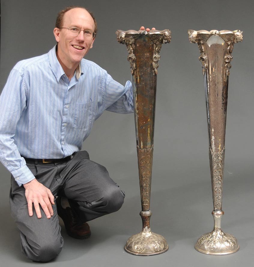 Pair of Victorian Silver Plated Floor Vases: each with three winged cherubs along the rim embossed with foliate design coming up from the base 40" high, 10" diameter English late 19th century estimate 1000/1500 Buyer is responsible for arranging