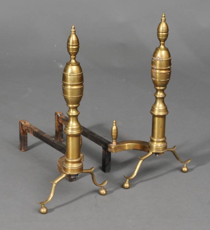 Pair of Sheraton Style Brass Andirons: each 20" high estimate 200/300 Shipping available within the Continental USA (excludes insurance) $75. International shippers are responsible for arranging 3rd party shipping.