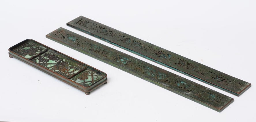 Tiffany Studios Pen Tray and Blotter Ends: Grapevine pattern pen tray 9 5/8" long blotter ends 19" long estimate 400/600 SHIPPING INFORMATION Shipping available within the Continental USA (excludes insurance) $30. International buyers are resp