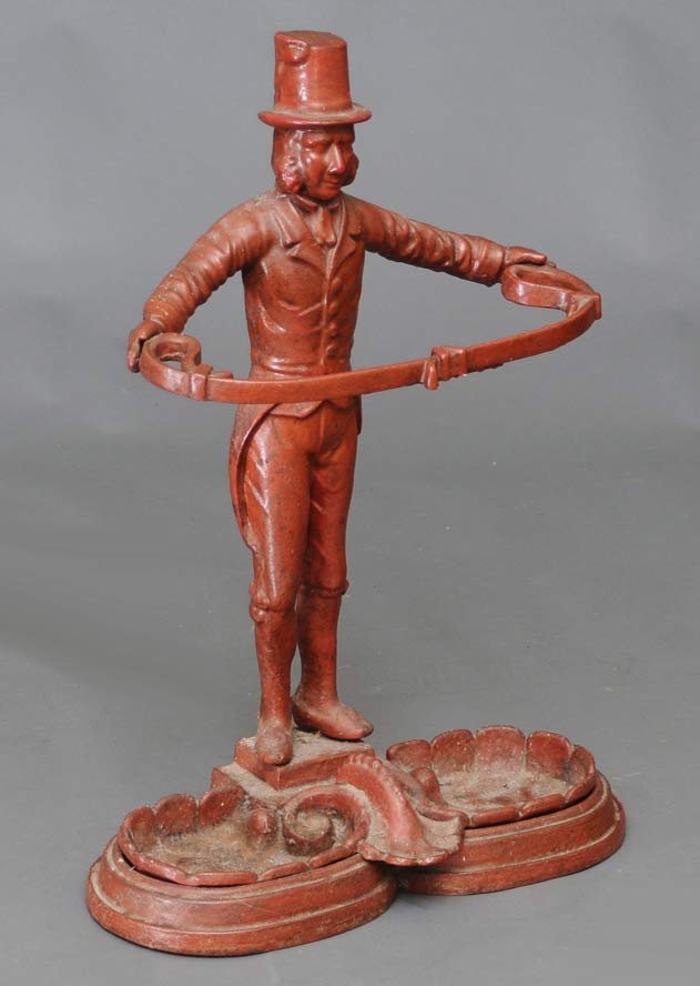 Daper Dan Cast iron Umbrella Stand: 27 1/2" high late 19th century estimate 200/300 SHIPPING INFORMATION Buyer is responsible for arranging 3rd party shipping.