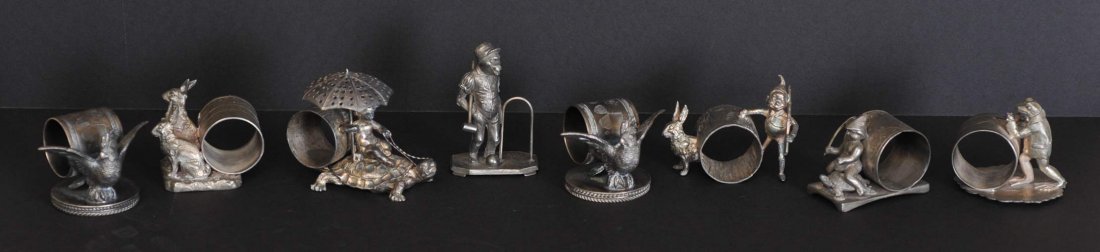Group of 8 Silverplated Napkin Rings: including figural the majority are Victorian estimate 750/1000 SHIPPING DETAILS: Shipping available within the Continental USA (excludes insurance) $35. International buyers are responsible for arrang