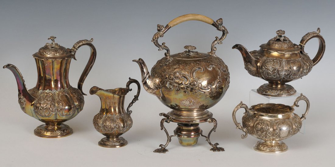 English Sterling Silver 5 Piece Tea Set: hallmarked London, 1838 with repousse decoration of scrolls and flowers SHOULD READ 115 troy ounces kettle 13" high, coffee 10", tea pot 6 1/2" each monogrammed "H.C.B." estimate 2500/3500