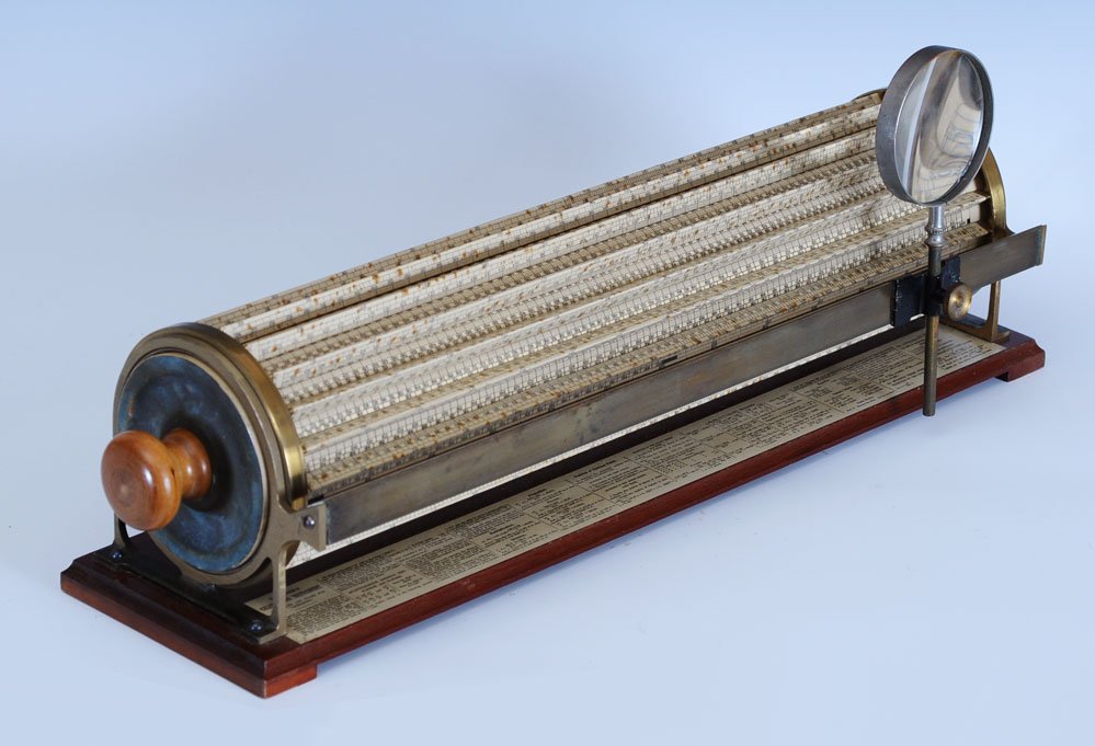 Thatcher's Calculating Instrument: a cylindrical slide rule, patented in 1881 by Edwin Thatcher Keuffel & Essex, New York with mahogany base 22" long, together with the original mahogany Thatcher's Calculating Instrument