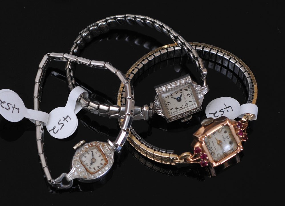 Three Ladies Wrist Watches: including one platinum and diamond, one palladium and diamond,and an Oneida 14kt gold, all with stainless bands