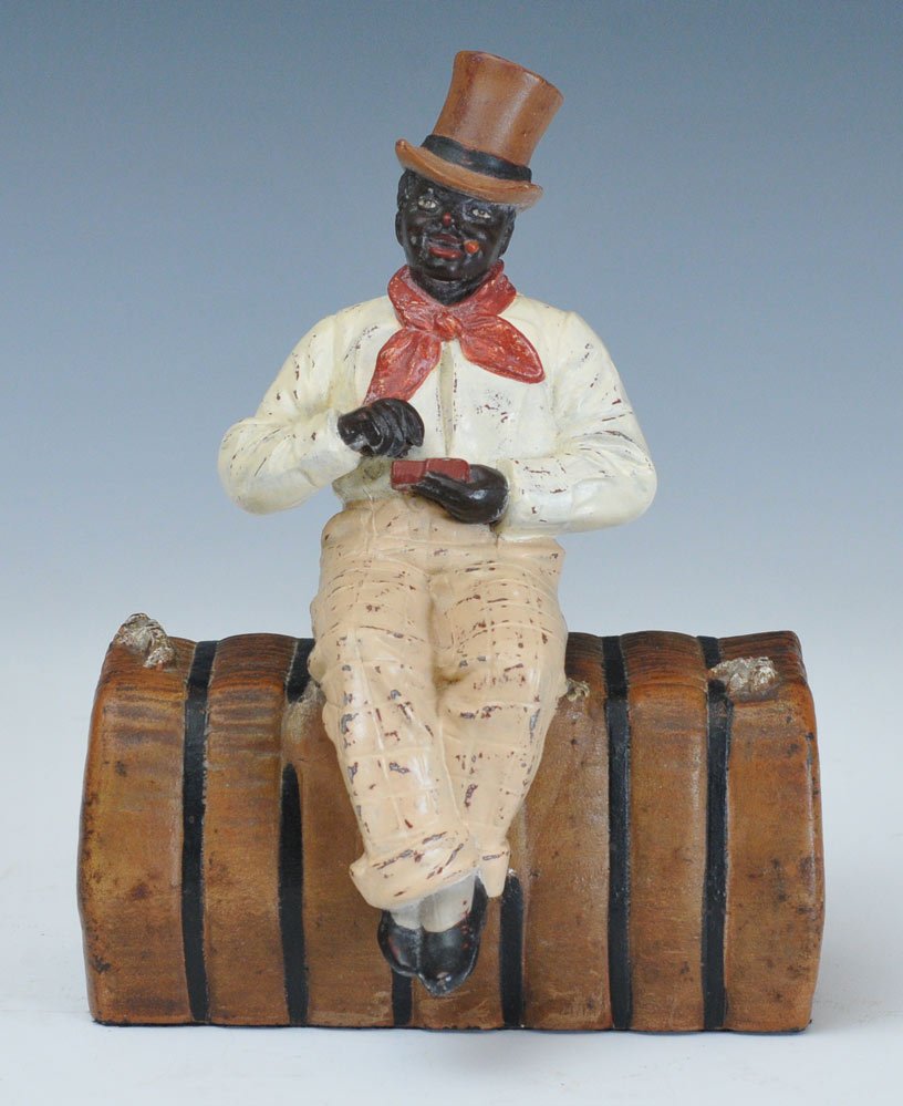 Man on Bale of Cotton Doorstop: cast iron base with spelter figure 8 3/4" high early 20th century