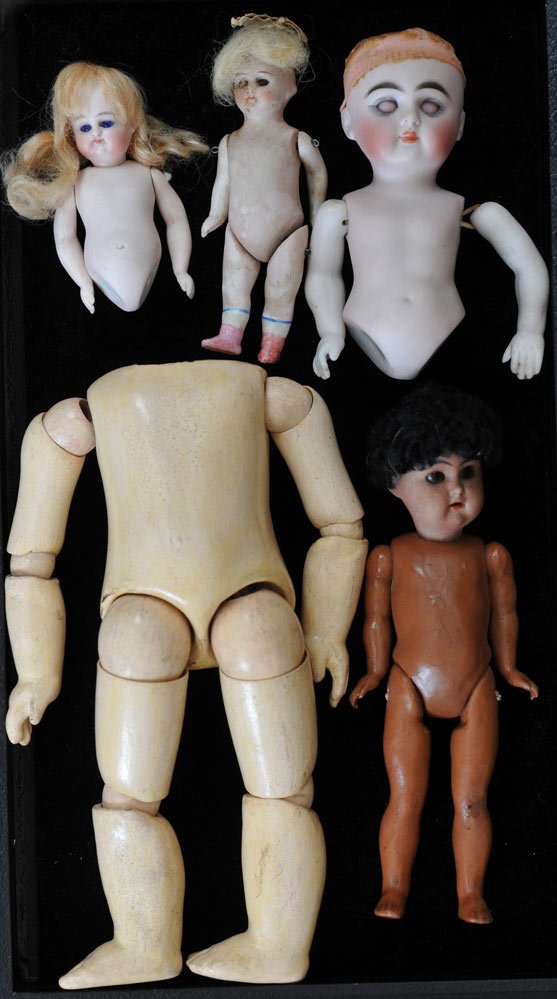 Tray Lot of Bisque Doll Parts: including four with heads and a Jumeau body, 8 1/2" long all early 20th century
