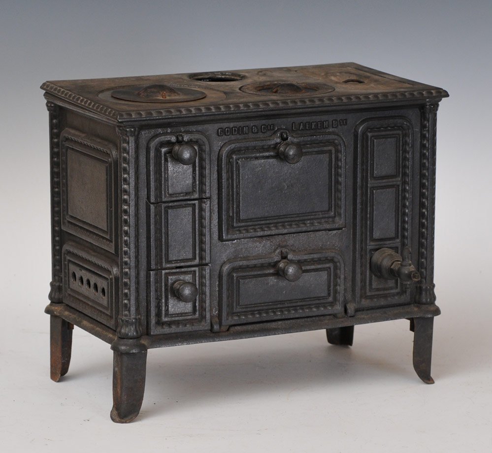Godin & Cie French Cast Iron Stove: 7" x 13", 11" high circa 1890 together with a group of iron pots and pans