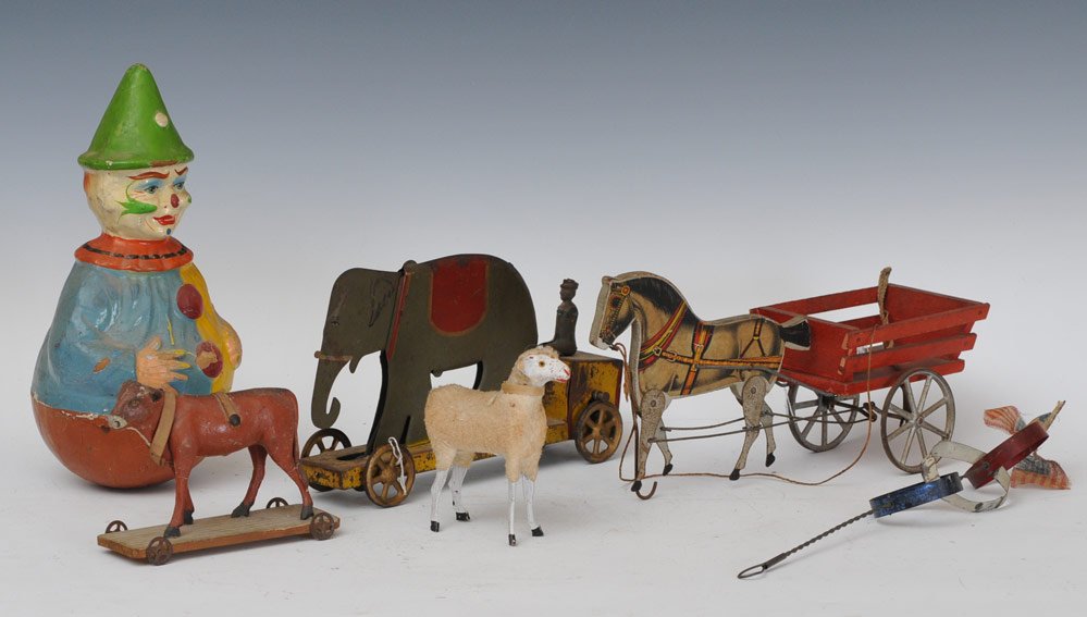Schoenhut Roly Poly Clown: 12" high together with elephant hill circus toy 10 1/2" high, Gibbs 13" paper and wood horse cart, cloth lamb, parade stick toy, and composition cow