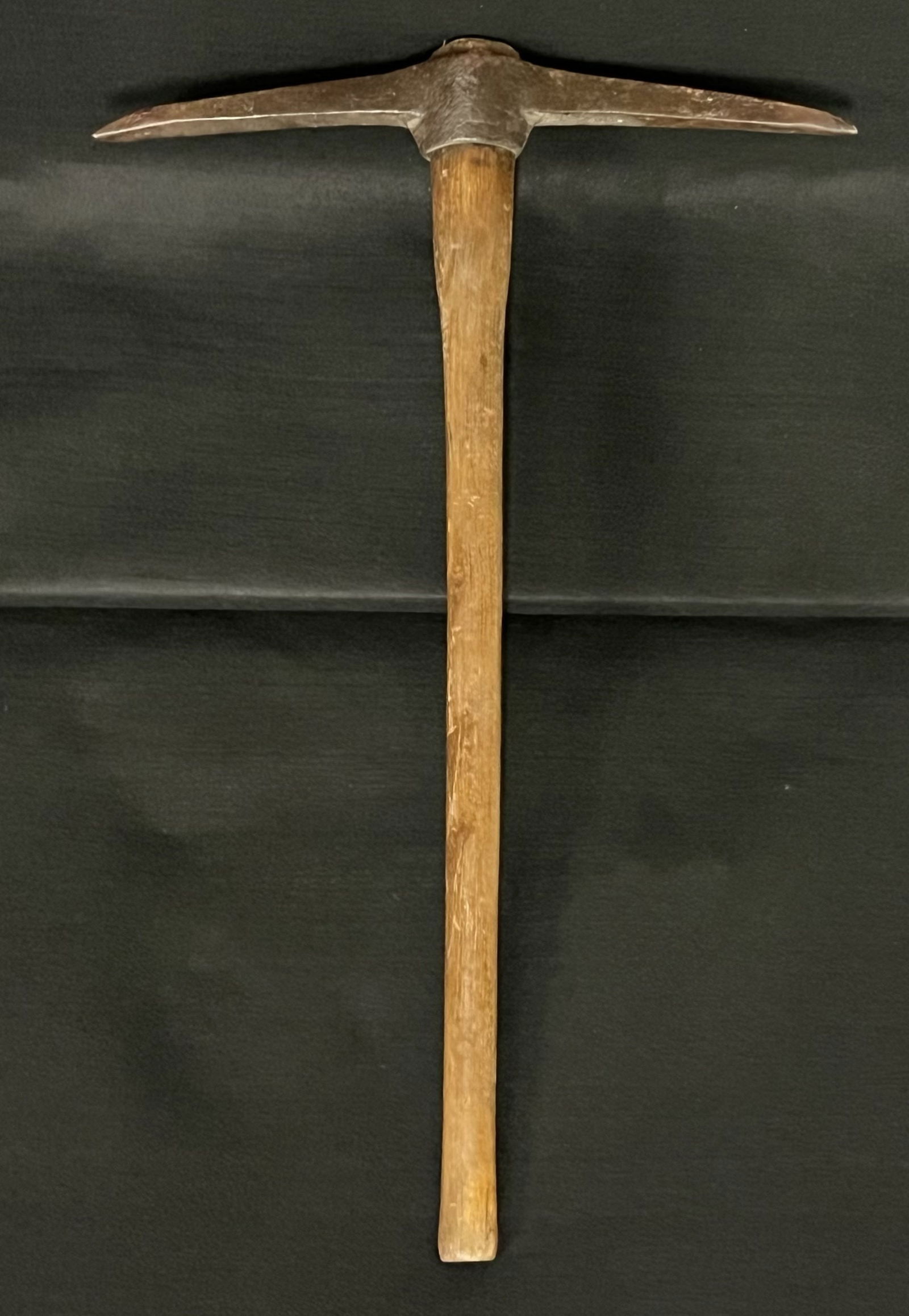 Vintage Wooden Handle Miner's Pick Axe: The pick axe is generally used for breaking up ground or rocks. However, the name indicates this style of pick axe was also used by miners. Maintaining the pick axe will insure a good long life for th