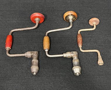 Antique Hand Drills: The group of 3 antique hand crank drills are still functional but have some much loved wear & tear. The two larger drills are racheting bit brace hand drills. The ratcheting bit brace hand drill with