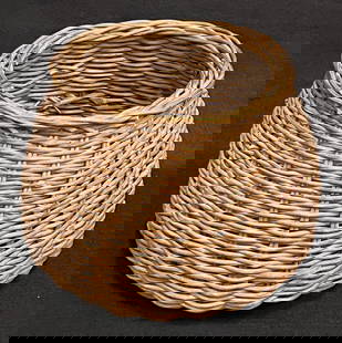 Small Opening Countrystyle Round Wicker Basket: The small opening for this countrystyle wicker basket allows for stashing items in an attractive container. It appears to be in good condition. Bottom of the basket shows some discoloration. (12" x 12
