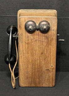 Antique Wooden Wall Phone: An antique oak wall phone is a great sign of the progress made in the country home of yesteryear. The bells and case finish are in good condition. (14" x 7" x 17") (19.5lbs.) Estimate: $160 - $200