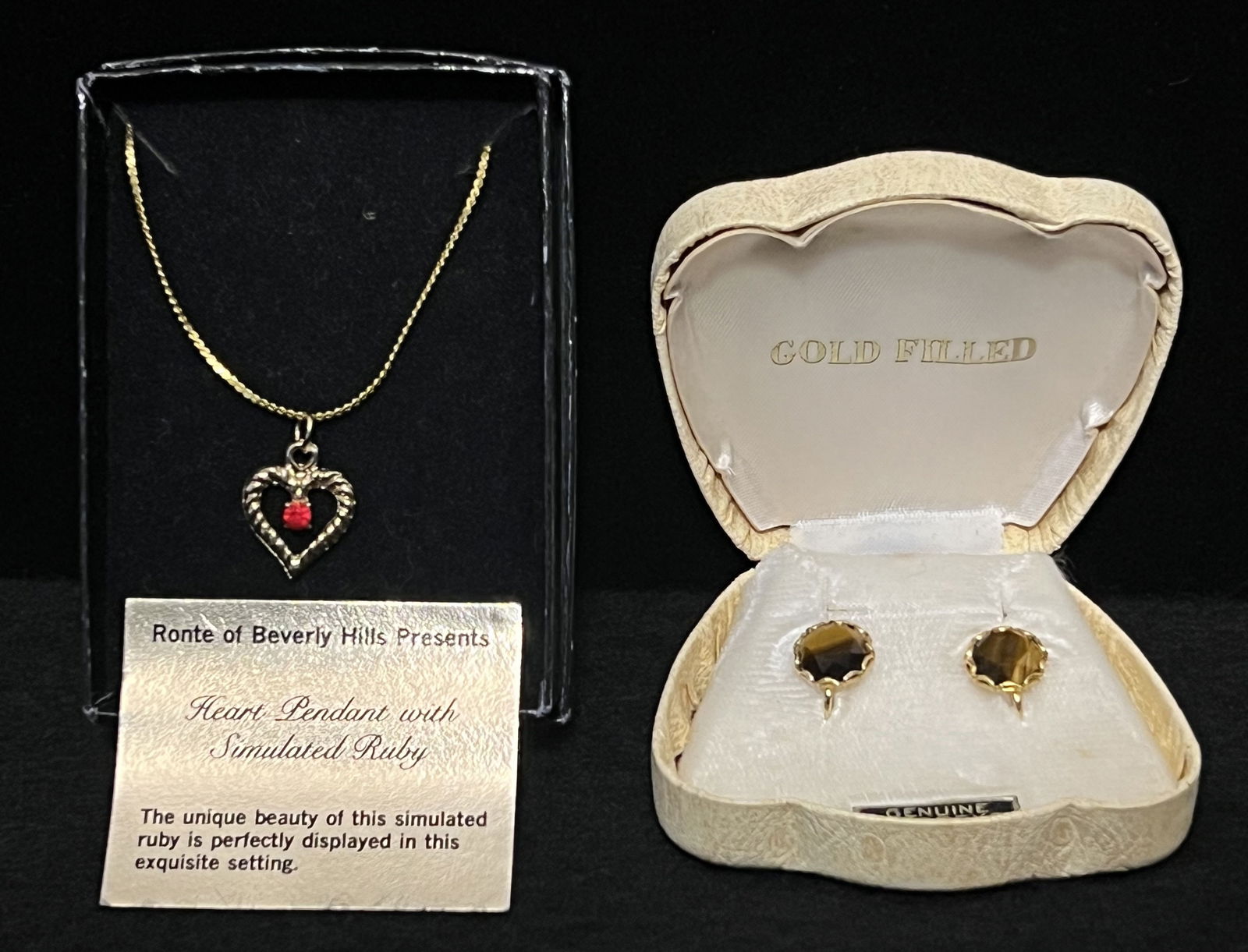 Pair of Jewelry Treasures: The Ronte of Beverly Hills Presents a Heart Pendant with Simulated Ruby necklace in original box. It's in perfect condition and measures 9.25" in length. (3.25" x 2.25" x 1") Pair of 12k gold filled g