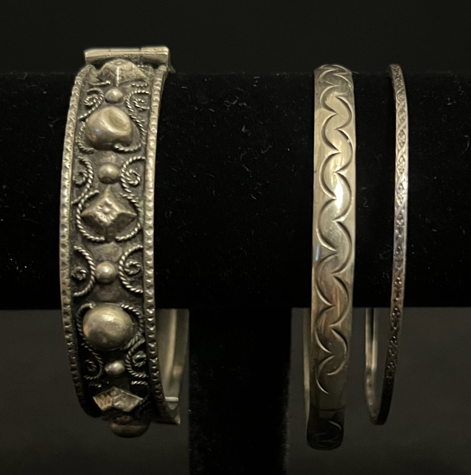3 Sterling Bracelets: The detailed hinged sterling bracelet is quite unique. The design includes various shapes, a darker background to accent the pattern and a silver rim on the top & bottom. It is missing the pin to hold