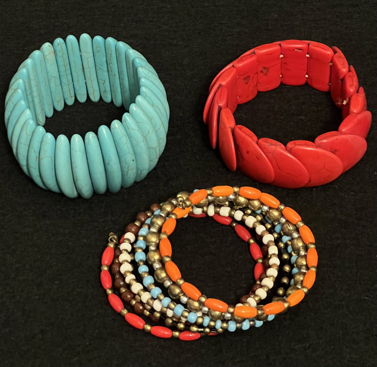 3 Colorful Costume Bracelets: The turquoise colored bracelet is made with 2 bands of elastic & 30 slim pieces (each 1.5" tall). The bracelet has a crackled design on each piece and they are all secure and in good condition. Becaus