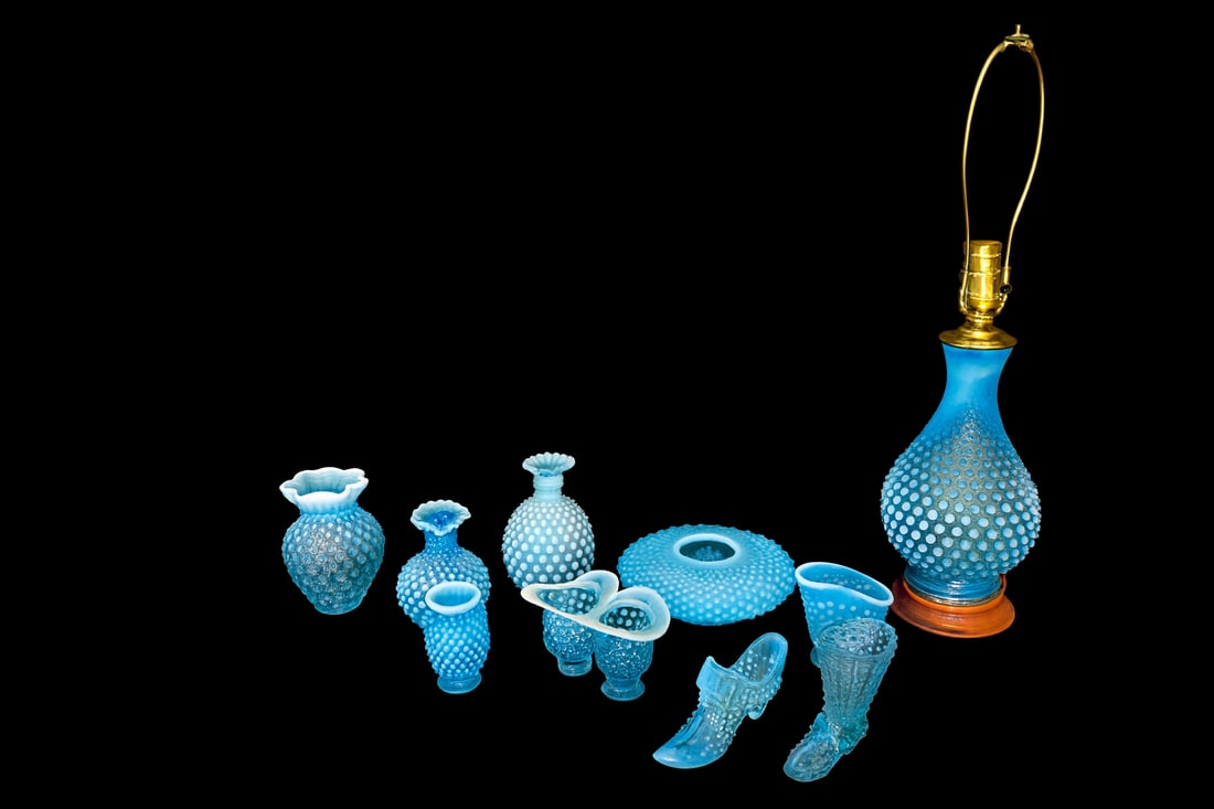 Fenton Blue Opalescent Hobnail Glass Collection — 11 Pieces Including Lamp: Eleven-piece collection including electric table lamp, vases, ruffled bowls, and two hobnail shoes. Lamp requires rewiring.Lamp 19” H overall; vases range 3”–6” H.