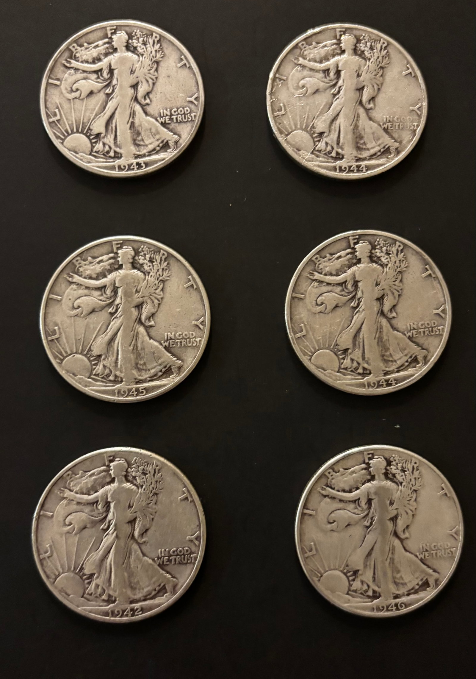 18 Walking Liberty Half Dollars – Mixed WWII Dates (1942–1946) – 90% Silver: Eighteen Walking Liberty halves from WWII era with strong silver value.