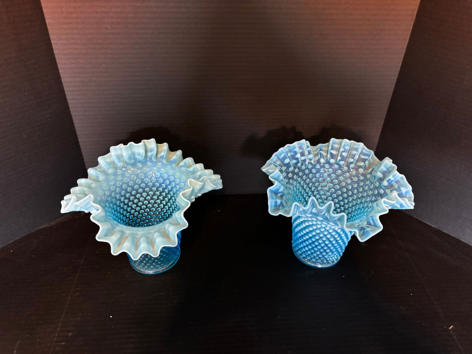 PAIR OF FENTON BLUE OPALESCENT HOBNAIL CRIMPED VASES: Pair of mid-century Fenton blue opalescent hobnail vases with deeply ruffled rims and strong opal fade. Approx. 5.75” H × 6.75” W (at rim, each)