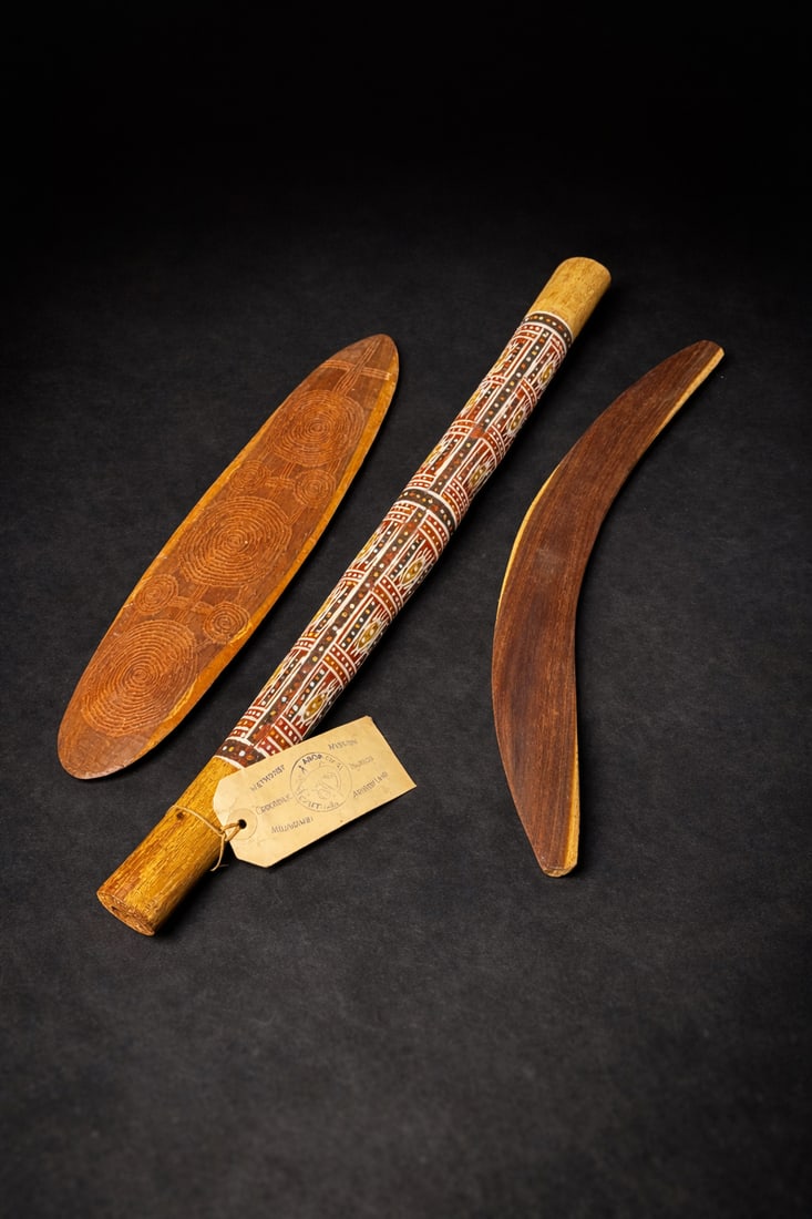 Aboriginal Australian Painted Wood Implements, Arnhem Land (3 pcs): Group of hand-carved and painted Aboriginal Australian wooden implements, including one long ceremonial club or digging stick with traditional ochre and dot decoration and original paper tag referenci