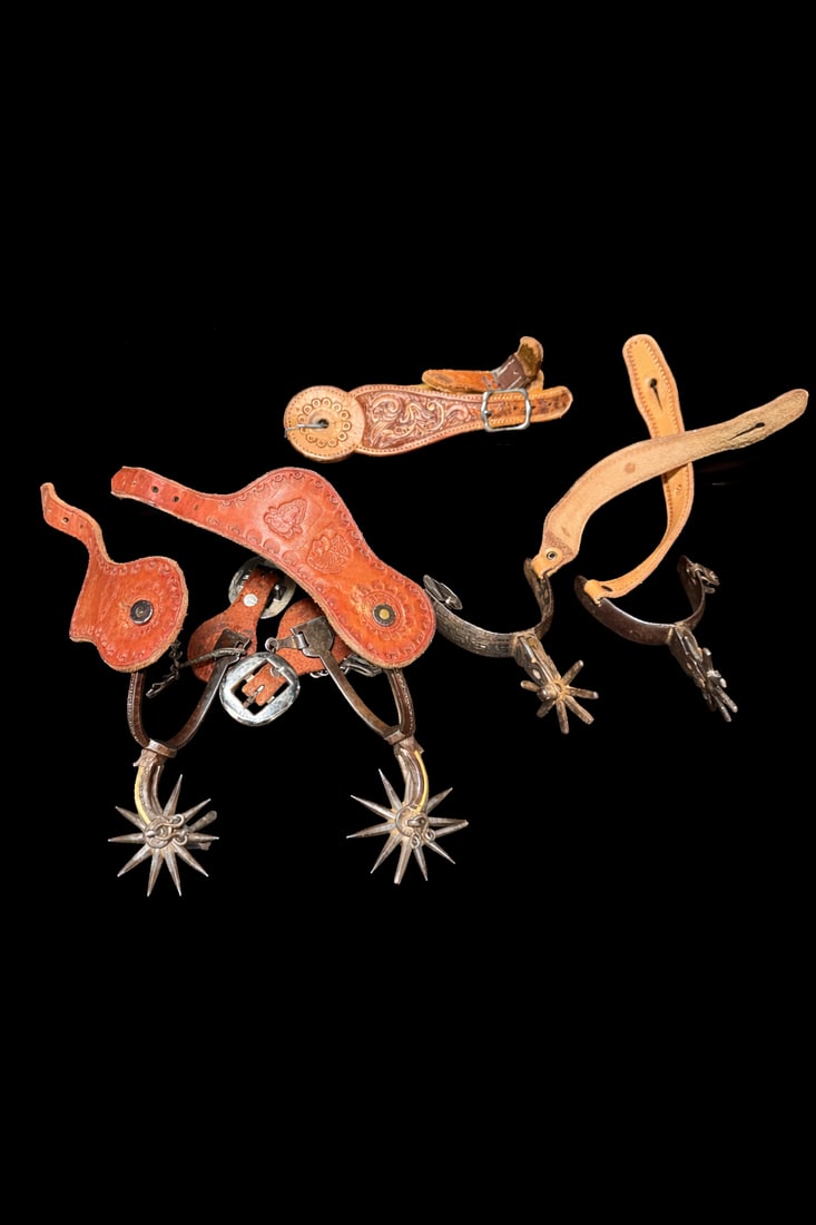 Vintage Western Cowboy Spurs & Leather Spur Straps (2 pairs spurs + 1 strap set): Vintage Western Cowboy Spurs & Leather Spur Straps, lot of 2 pairs steel star-rowel spurs incl. stamped “Tashiko Reg” pair plus 1 set hand-tooled leather spur straps; spur bands approx. 3–3.