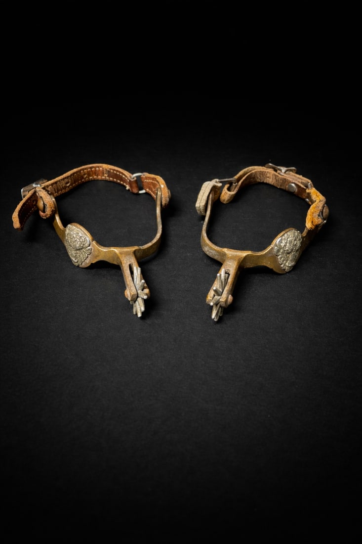 Pair of Antique Western Cowboy Spurs with Leather Straps, Brass & Steel: Pair of Antique Western cowboy spurs with brass scalloped heel bands, steel rowels, and original leather straps with metal buckles. Classic working-ranch construction with authentic age wear; leather