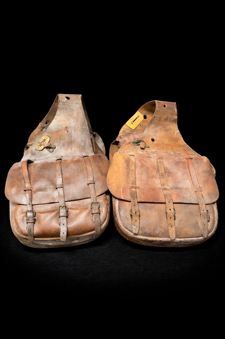 Matched Pair Vintage Leather Saddle / Motorcycle / Bicycle Bags: Matched Pair Vintage Leather Saddle / Motorcycle / Bicycle Bags, heavy brown leather w/ triple buckle closures per bag, canvas-lined interiors, original brass/steel hardware, approx. 12.5”W x 42