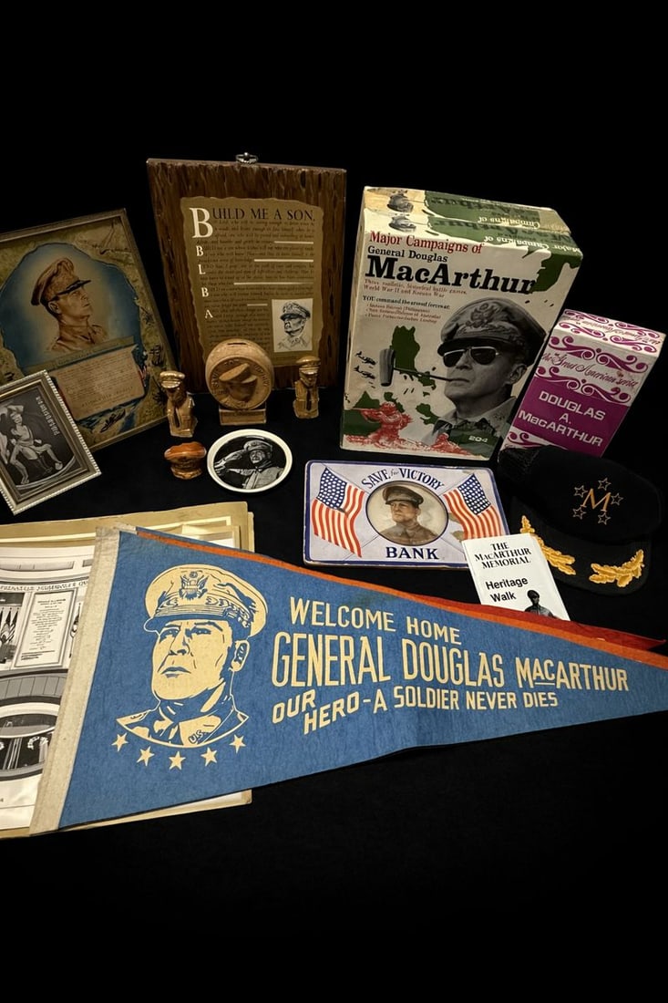 Large mixed MacArthur memorabilia: MacArthur memorabilia including 6 pennants approx. 29"W , 2 boxed games, 4 memorial prints approx. 17.5" x 11.5", figurines 2-3", bank, plate, portrait, plaque, banner 12.5" x 8.5", empty decantur box