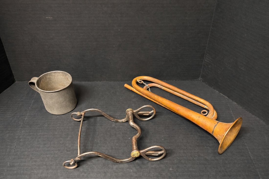Antique mixed military lot including cast metal mug, brass signal horn, and U.S. Army horse curb bit (1 of 5)