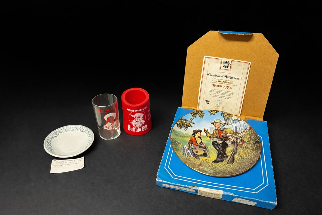 Buffalo Bill Western Memorabilia Group (4): incl. limited-edition collector plate w/ COA & box, souvenir tumbler, red “Knight of the Plains” cup, and patterned dish w/ provenance note. Plate issued by Perfection in Porcelain from the Am