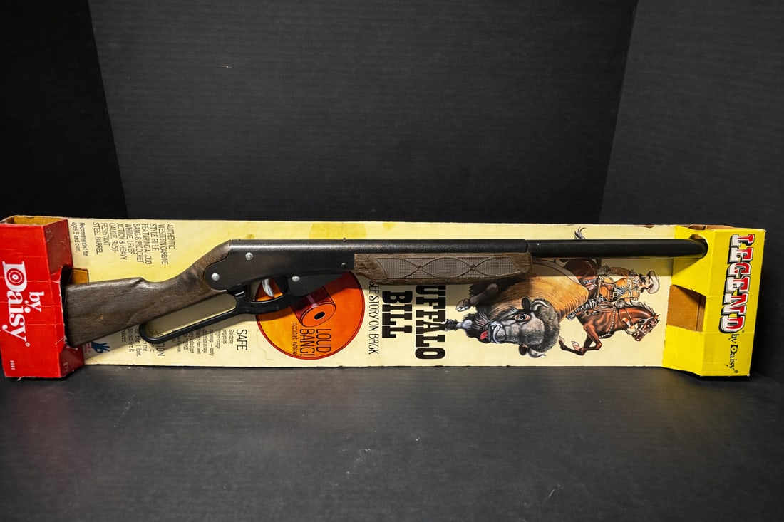 Daisy “Legend”Buffalo Bill Lever-Action Toy Rifle w/ Original Box: Vintage Daisy lever-action toy rifle, Buffalo Bill “Legend” model, featuring simulated wood-grain stock, metal-look barrel, and loud bang/ricochet whine action. Includes original illustrated b