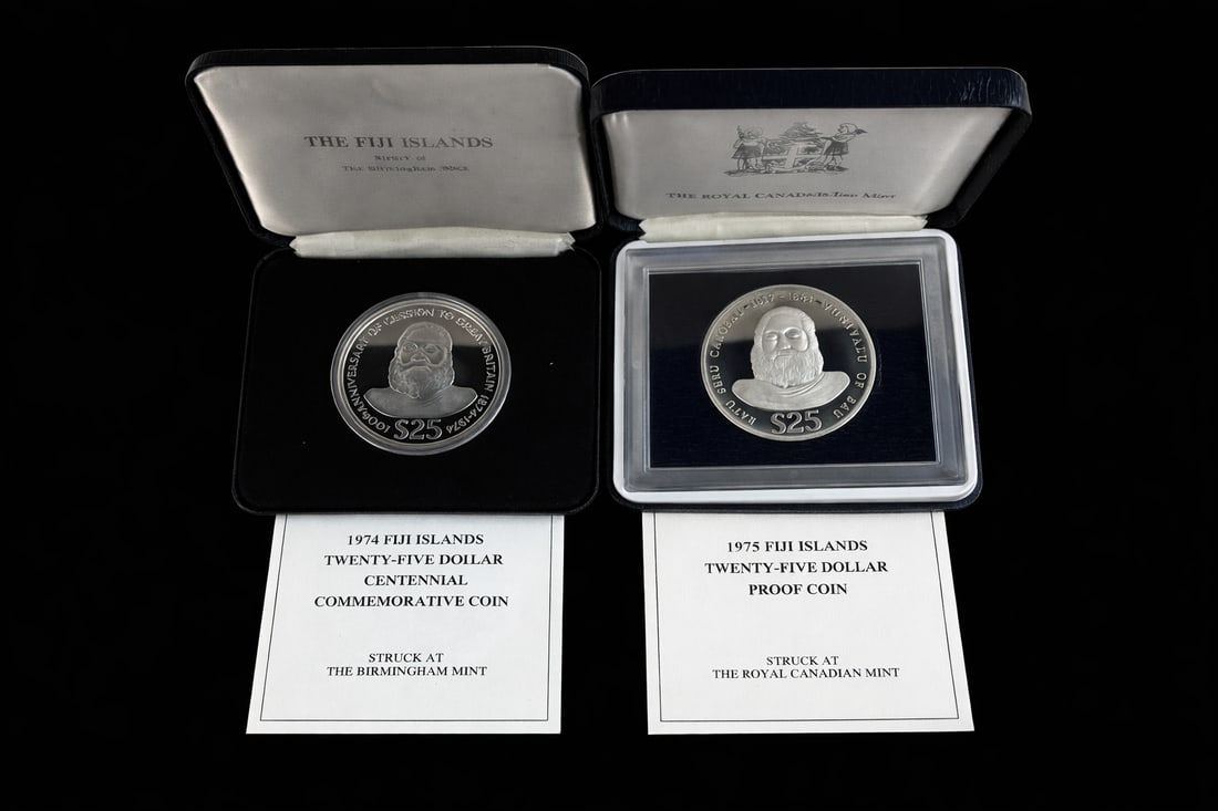 Fiji Islands 1974 & 1975 $25 Silver Proof Coins w/ Box: Pair of Fiji Islands $25 Silver Proof Coins including:• 1974 Centennial of Cession to Great Britain $25 (struck at Birmingham Mint)• 1975 $25 Proof Coin (struck at Royal Canadian Mint)Both h