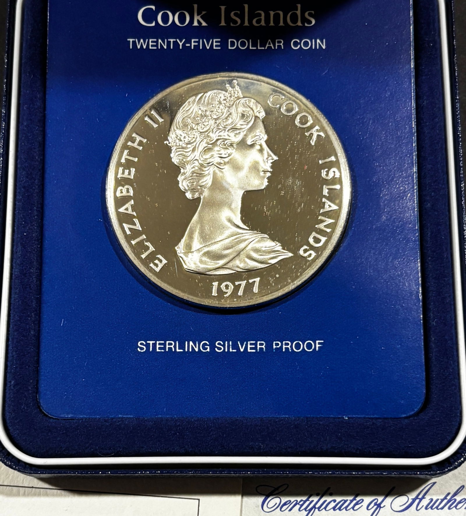 1977 Cook Islands $25 Sterling Silver Proof Coin Queen Elizabeth II Jubilee w/ Box & COA: 1977 Cook Islands $25 commemorative proof coin issued for the Silver Jubilee (1952–1977) of Queen Elizabeth II. Struck in .925 sterling silver by the Franklin Mint with frosted devices and mirrored