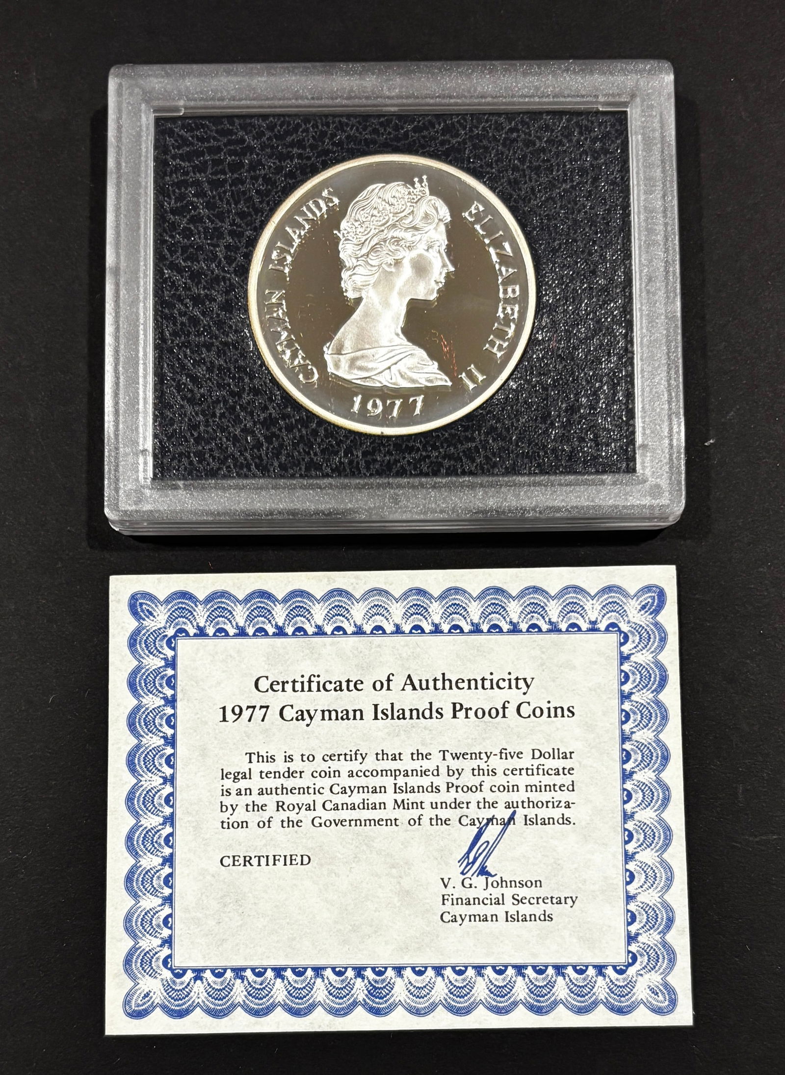 1977 Cayman Islands $25 Silver Jubilee Proof Coin With COA: 1977 Cayman Islands twenty-five dollar proof coin commemorating the Silver Jubilee of Queen Elizabeth II, struck by the Royal Canadian Mint and housed in original protective capsule with accompanying