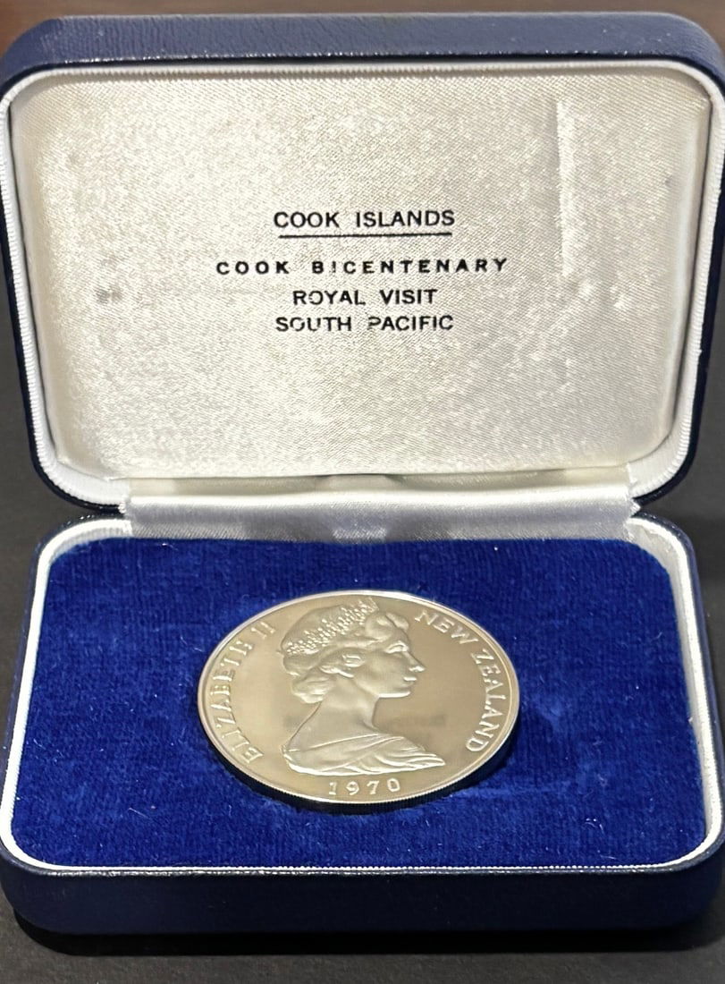 1970 Cook Islands James Cook Bicentenary Proof Silver Dollar In Case: 1970 Cook Islands proof silver one dollar commemorative issued for the Cook Bicentenary Royal Visit South Pacific celebration, featuring Queen Elizabeth II portrait dated 1970 and reverse depiction